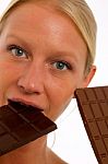 Woman Biting Chocolate Stock Photo