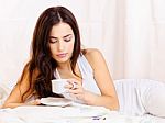Woman Drinking Coffee In Bed Stock Photo