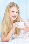 Woman Drinking Coffee In Bed Stock Photo