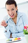 Woman Eating French Cookies At Home Stock Photo