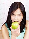 Woman Eating Green Apple Stock Photo