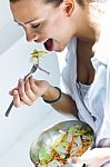 Woman Eating Salad At Home Stock Photo