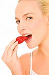 Woman Eating Strawberry Stock Photo