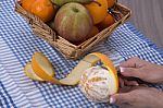 Woman Hands Peeling An Orange With A Knife Stock Photo