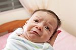 Woman Holding A Beautiful Sweet Hispanic Newborn Crying Stock Photo