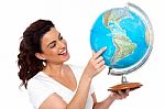 Woman Holding And Pointing Globe Stock Photo