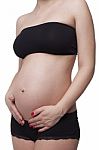 Woman Holding Her Pregnant Belly. White Background Stock Photo