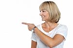 Woman In Casuals Pointing Sideways Stock Photo