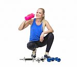 Woman In Fitness Clothing Drinking Stock Photo