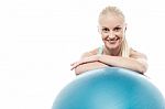 Woman In Gym Relaxing Beside Exercise Ball Stock Photo