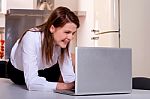 Woman In The Kitchen With Laptop Stock Photo