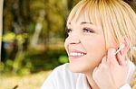 Woman In The Park With Earphones Stock Photo