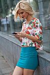 Woman In The Street Browsing A Smart Phone Stock Photo