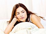 Woman Lie In Bed At Home Stock Photo