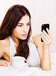 Woman Making Phone Call In Bed Stock Photo