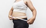 Woman Measuring Her Waistline Fat Tummy On Gray Background Stock Photo