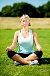 Woman Meditating Outdoors On A Sunny Day Stock Photo