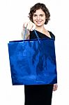 Woman Offering You Bright Blue Shopping Bag Stock Photo