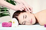 Woman On Ear Massage In Salon Stock Photo