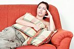 Woman On Sofa Having Headache Stock Photo