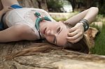 Woman On The Beach Lying On Branch Stock Photo