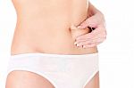Woman Pinching Stomach For Skin Fold Test Stock Photo