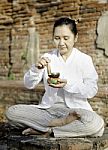 Woman Playing A Tibetan Bowl, Traditionally Used To Aid Meditati Stock Photo