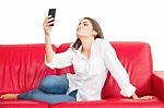 Woman Puckering While Taking Selfie On Sofa Stock Photo