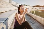 Woman Relaxing After Sports And Drinking Water Stock Photo