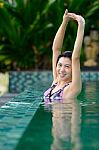 Woman Relaxing In The Swimming Pool Stock Photo