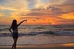 Woman Silhouette In The Sunset And Pointing Stock Photo