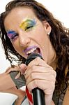 Woman Singing Into Microphone Stock Photo