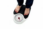 Woman Standing On Weighing Scale Stock Photo