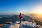 Woman Stands On The Peak Of Stone In Bukhansan National Park,seoul In South Korea And Watching To Sunrise. Beautiful Moment The Miracle Of Nature Stock Photo