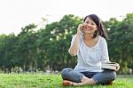 Woman Talking On Mobile Phone And Smiling Stock Photo