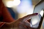 Woman Tapping On Tablet Stock Photo