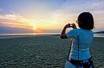 Woman Tourist Taking Photo On The Beach Stock Photo