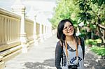 Woman Tourist With Camera Smile In The Thai Temple Stock Photo