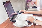 Woman Using Laptop With A Cup Of Coffee Stock Photo