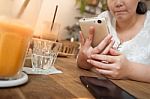 Woman Using Phone In Cafe Stock Photo