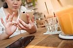 Woman Using Phone In Cafe Stock Photo