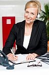 Woman Wearing Headset Writing Stock Photo