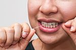 Woman With Dental Floss Stock Photo