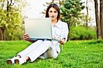 Woman With Laptop In Park Stock Photo