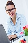 Woman With Laptop Working At Home Stock Photo