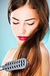 Woman With Long Hair Holding Comb Stock Photo