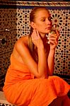 Woman With Perfume In Hand In The Bathroom Stock Photo