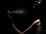 Woman With Perfume On Black Background Stock Photo