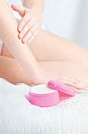 Woman's Hand Applying Cream Stock Photo