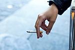 Womans Hand With Cigarette In The Street Stock Photo
